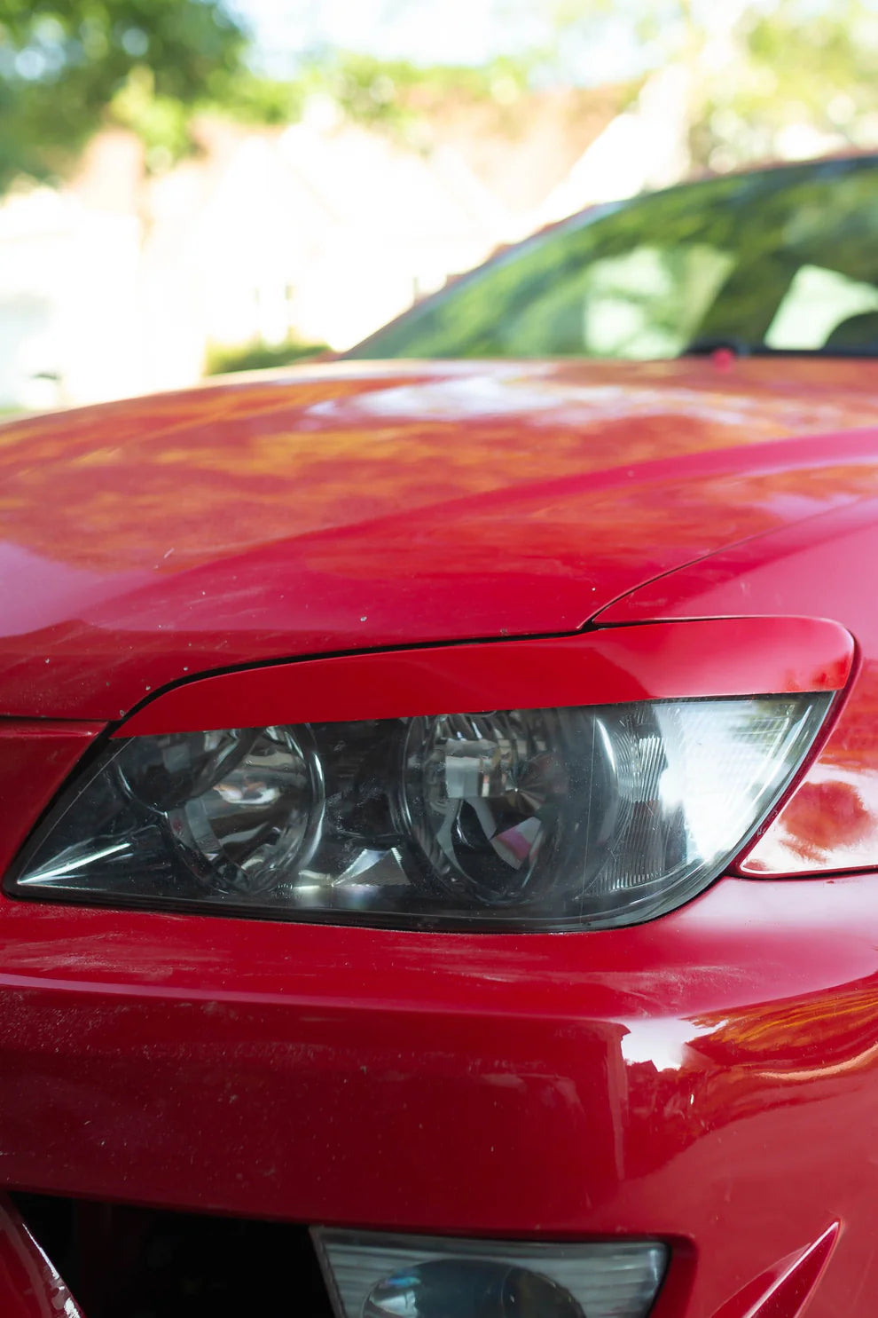 Dunlap Aero Solutions eyelids installed on Lexus IS300 on-car front view showing headlight trim styling appearance