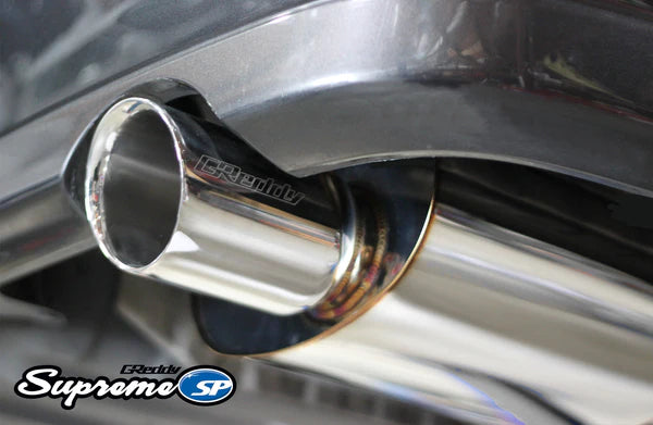 The polished stainless steel tip of a GReddy Supreme SP exhaust on an IS300, showing the etched GReddy logo and high-gloss finish