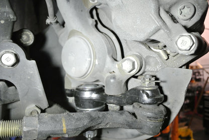 Detailed view of the Megan Racing drift knuckle installed on an IS300 with the outer tie rod attached to the shortened steering arm