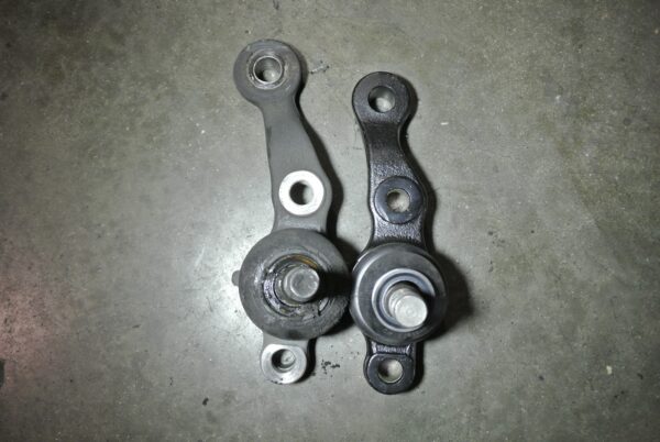 Visual comparison of the OEM Lexus IS300 front lower ball joint and the high-strength cast steel Megan Racing drift knuckle